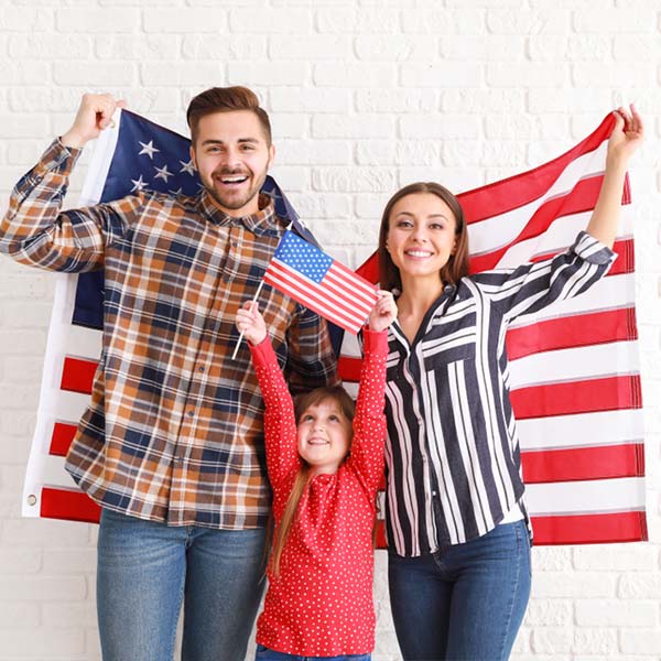 Happy,Young,Family,With,National,Flags,Of,Usa,Near,White